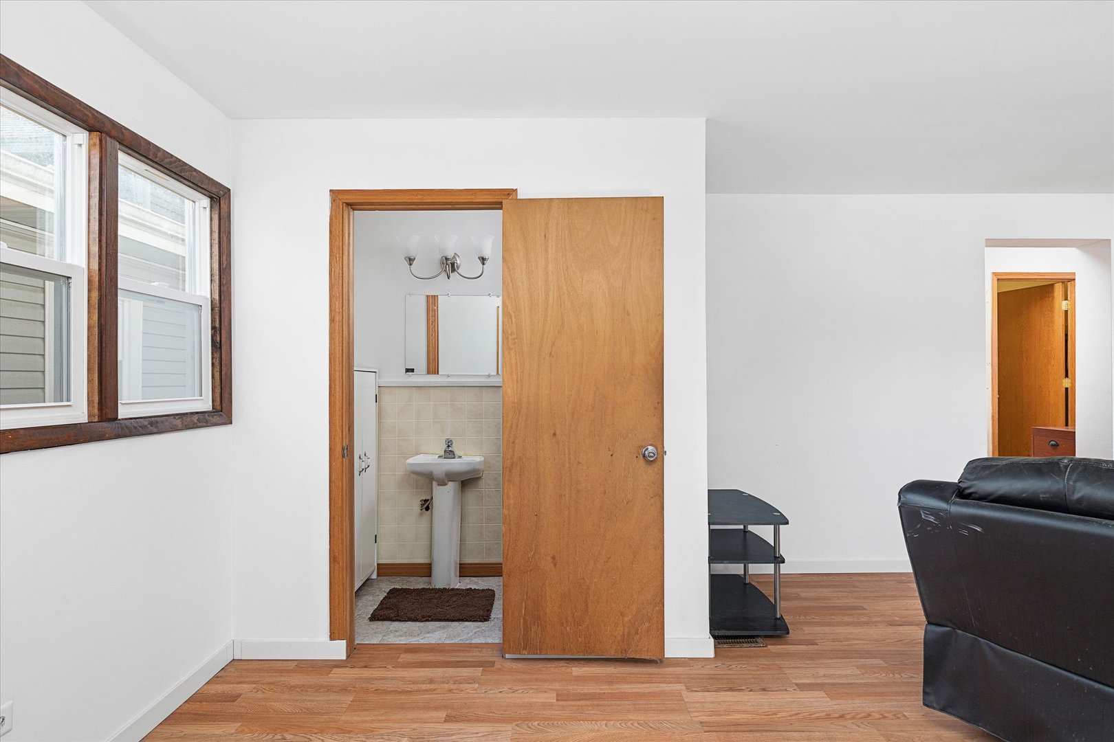 6236 Washington Street Chicago Ridge, IL 60415 - Photo 15 of 32 a view of a hallway with wooden floor and a bathroom