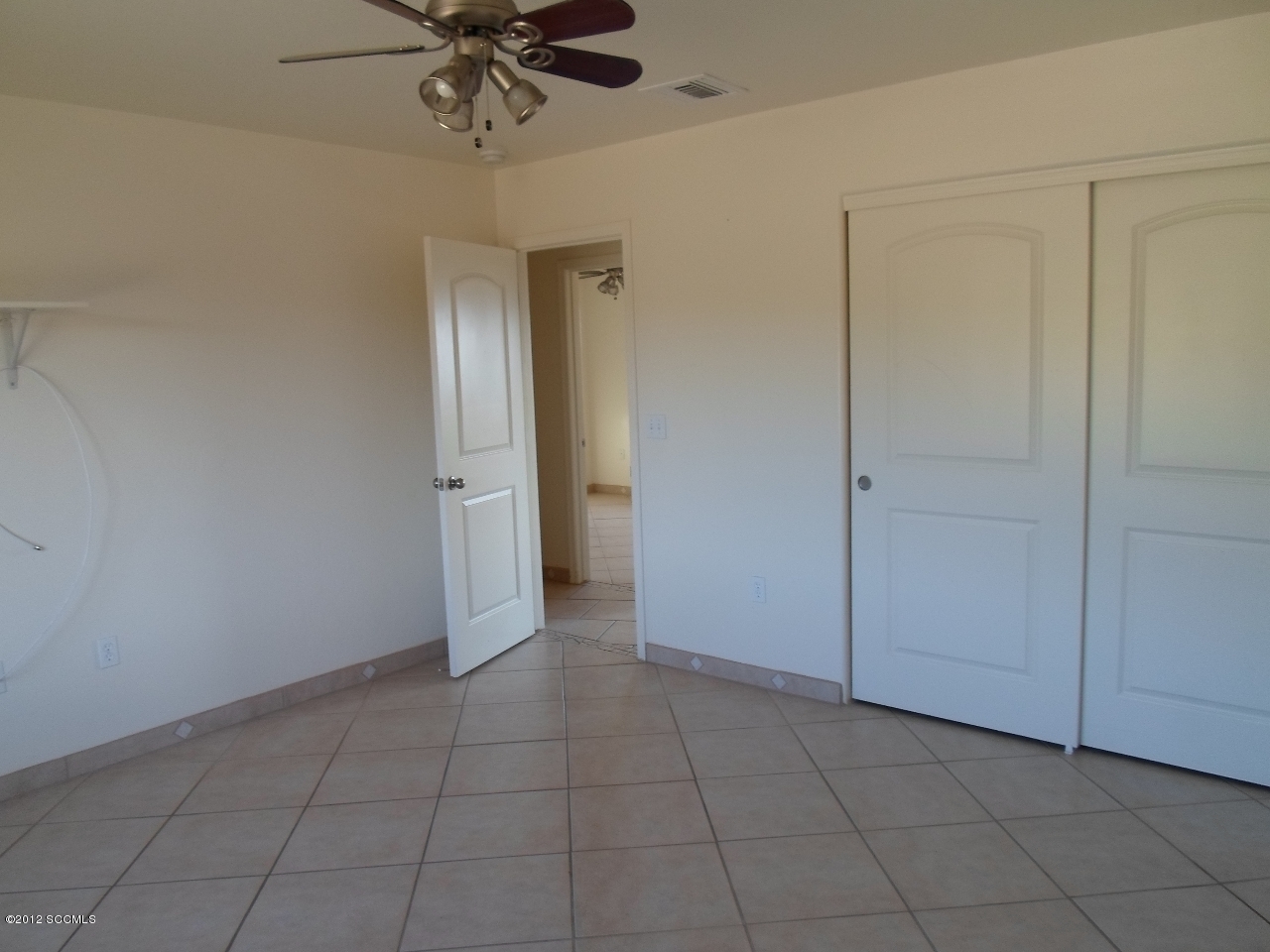 1435 Alisa Court Rio Rico, AZ 85648 - Photo 9 of 12 wooden floor in an empty room with a window