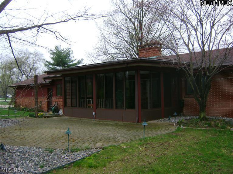 6612 South Ridge Road East Kingsville, OH 44048 - Photo 21 of 24 Rear of home showing Sunroom and paver patio ready for outdoor entertaining.