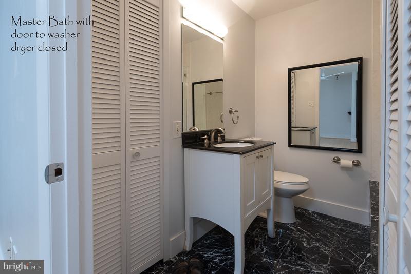 11302 Gatesborough Lane Reston, VA 20191 - Photo 19 of 30 a bathroom with a toilet a sink and mirror