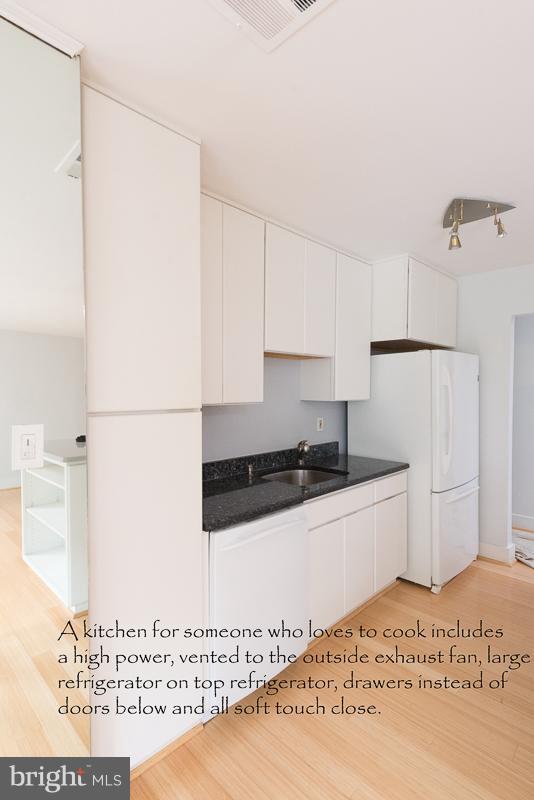 11302 Gatesborough Lane Reston, VA 20191 - Photo 7 of 30 a kitchen with a sink a stove and white refrigerator