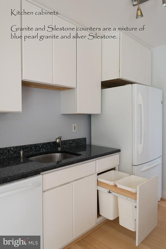11302 Gatesborough Lane Reston, VA 20191 - Photo 8 of 30 a kitchen with granite countertop white cabinets and white appliances