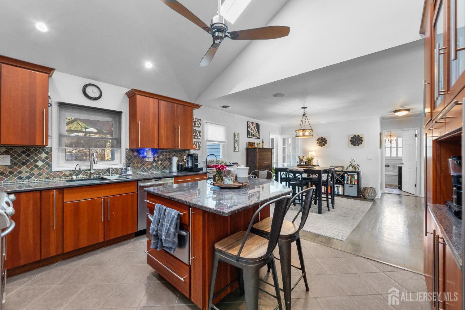 116 Player Avenue Edison, NJ 08817 - Photo 10 of 40 a kitchen with stainless steel appliances granite countertop table chairs sink and cabinets