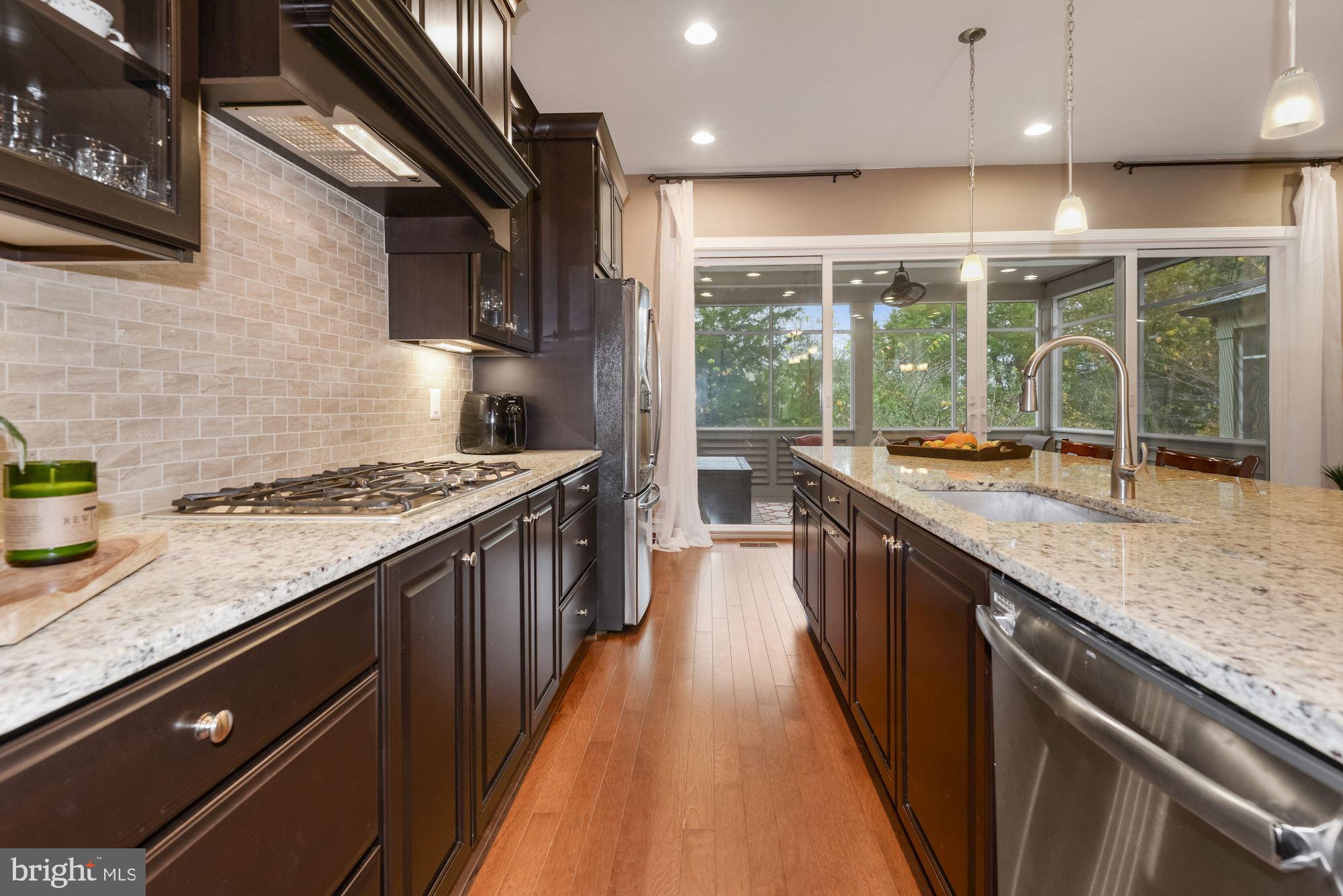 23524 Epperson Square Brambleton, VA 20148 - Photo 13 of 36 Kitchen with Granite and Travertine Backsplash
