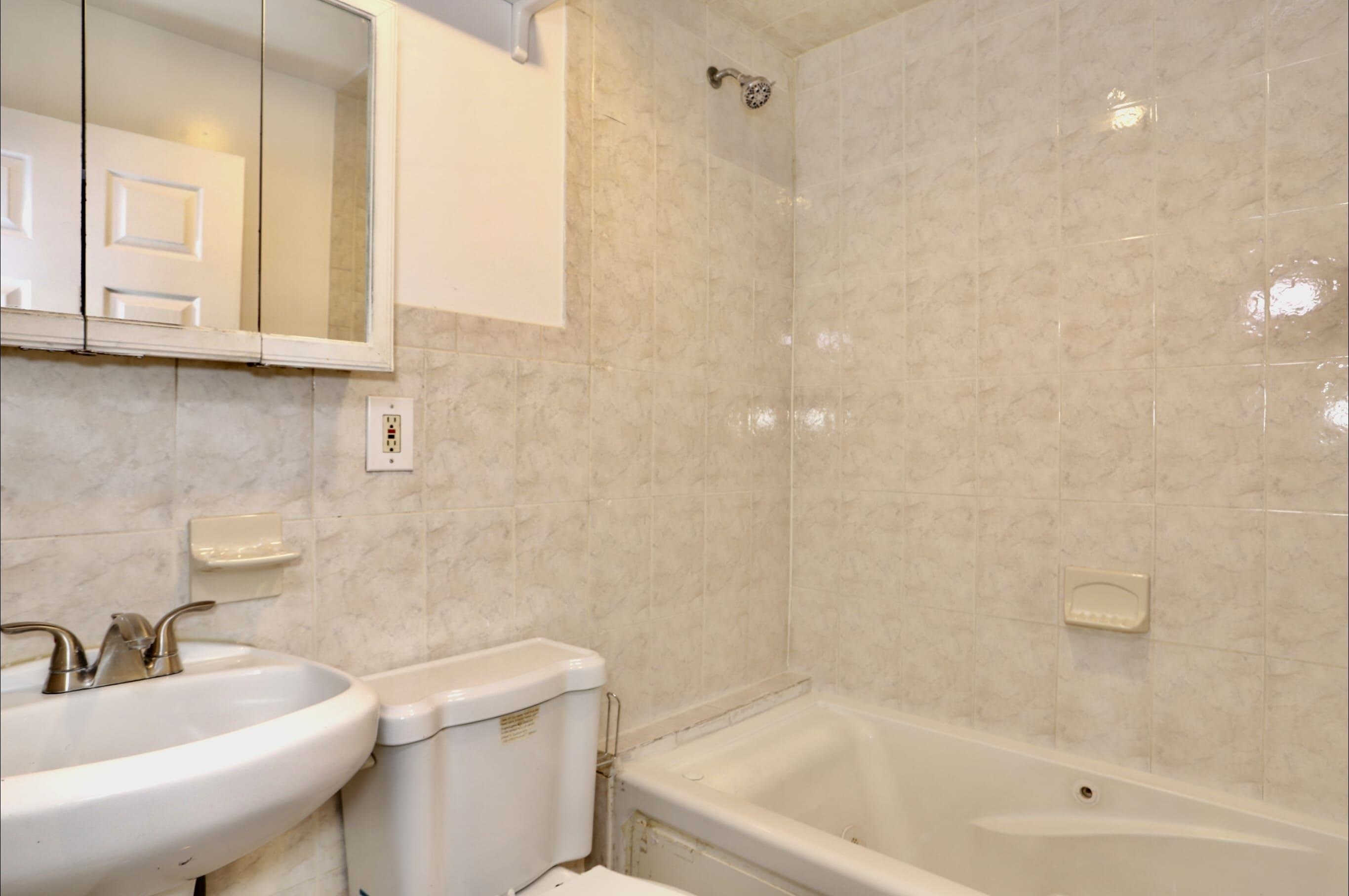 314 Paterson Plank Road, Unit 1B Union City, NJ 07087 - Photo 11 of 22 a bathroom with a sink a toilet and bathtub
