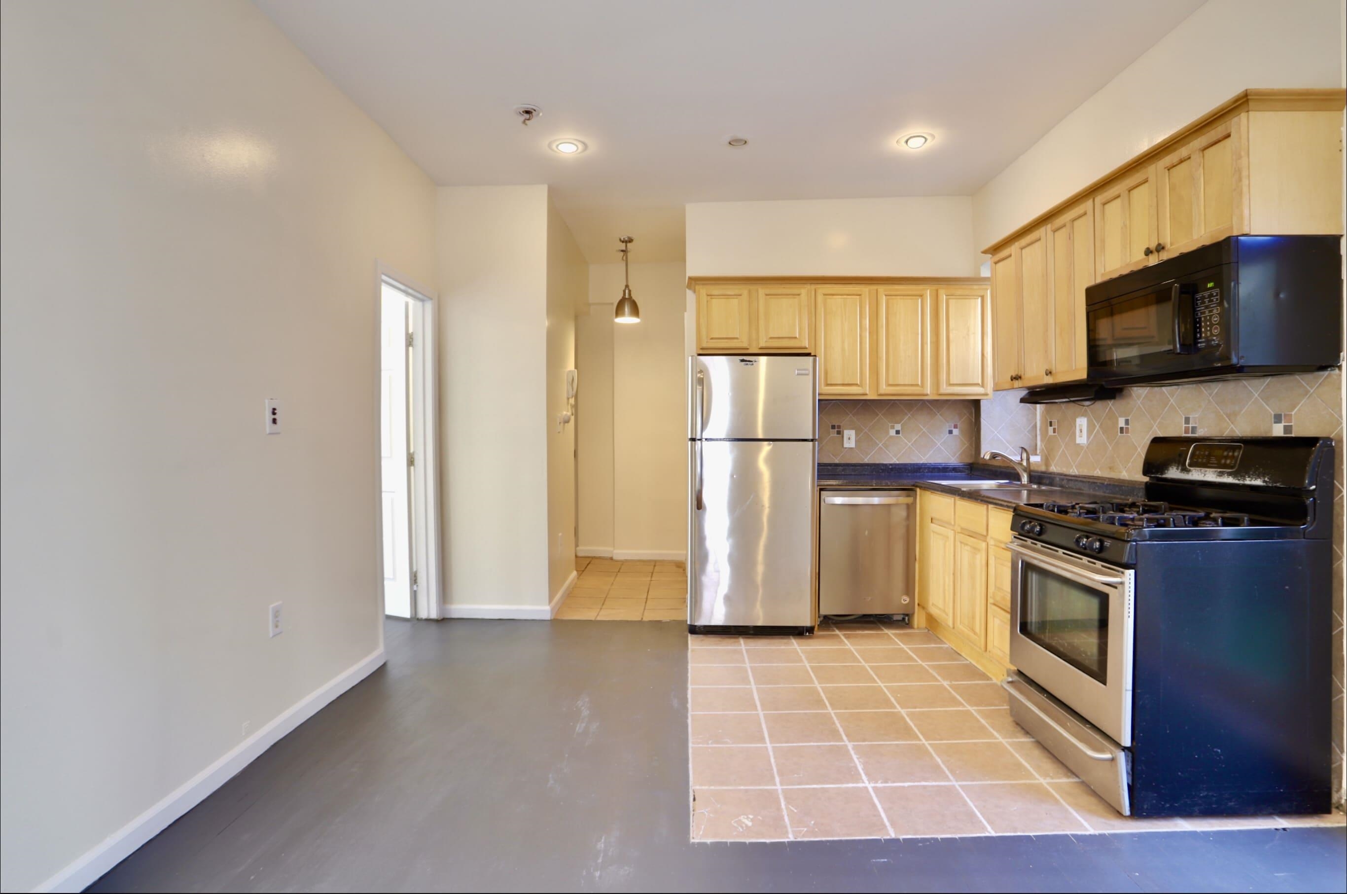 314 Paterson Plank Road, Unit 1B Union City, NJ 07087 - Photo 2 of 22 a kitchen with stainless steel appliances granite countertop a refrigerator a stove top oven a sink and dishwasher