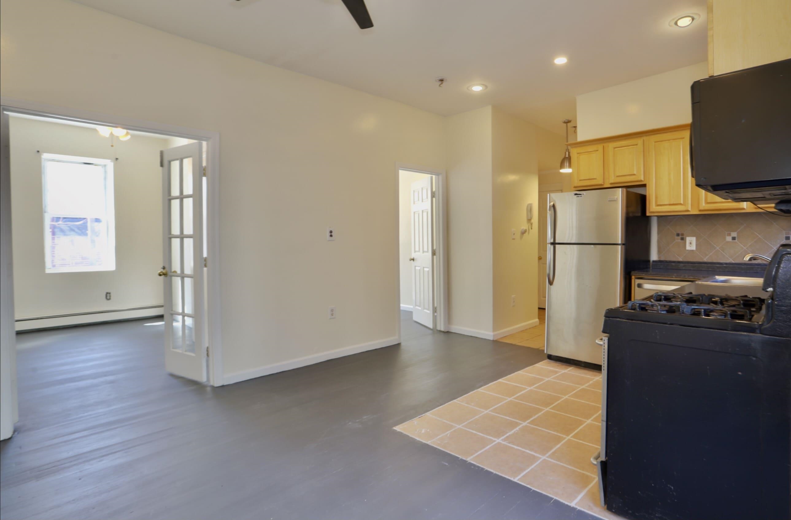 314 Paterson Plank Road, Unit 1B Union City, NJ 07087 - Photo 3 of 22 a view of a kitchen with refrigerator and wooden floor