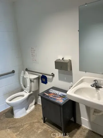a bathroom with a sink toilet and mirror