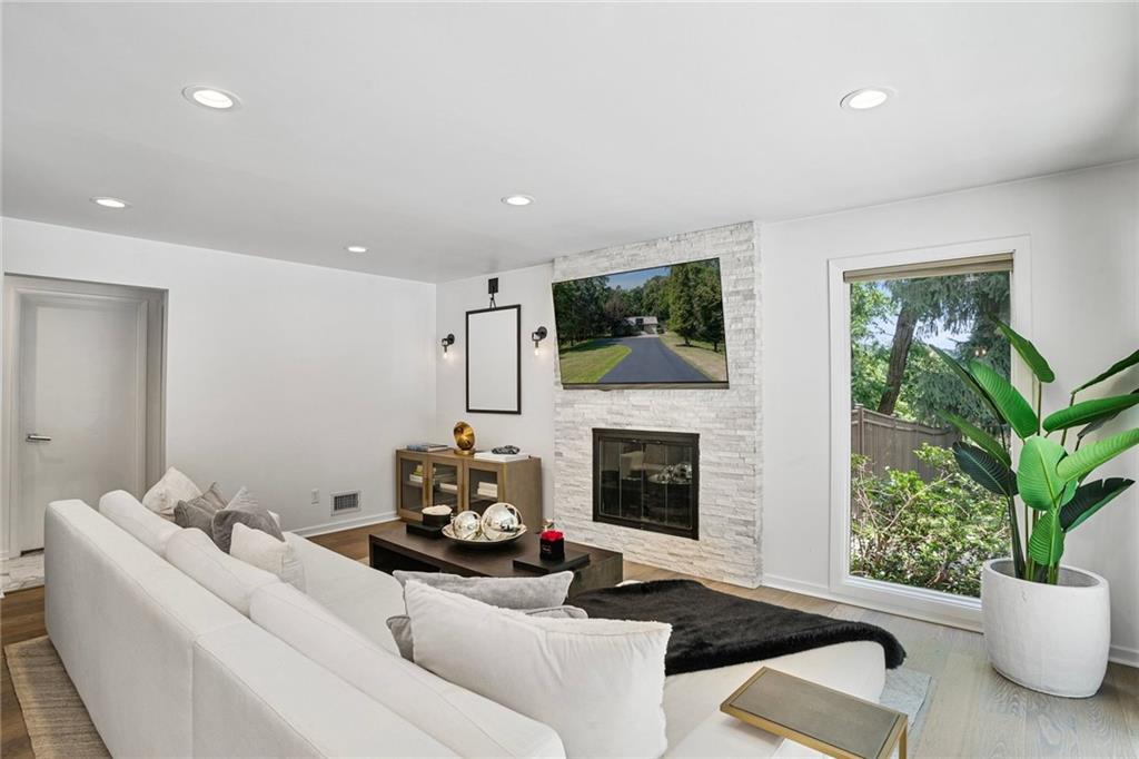 989 Braddock Road Pittsburgh, PA 15221 - Photo 16 of 50 a living room with furniture a flat screen tv and a fireplace
