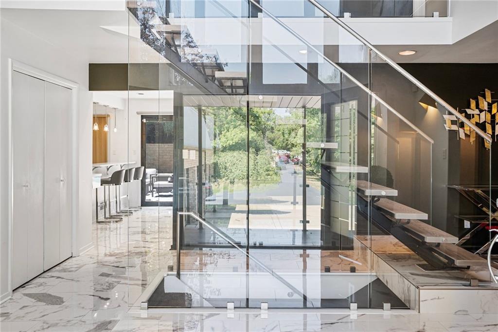 989 Braddock Road Pittsburgh, PA 15221 - Photo 18 of 50 a room with lots of windows and glass door