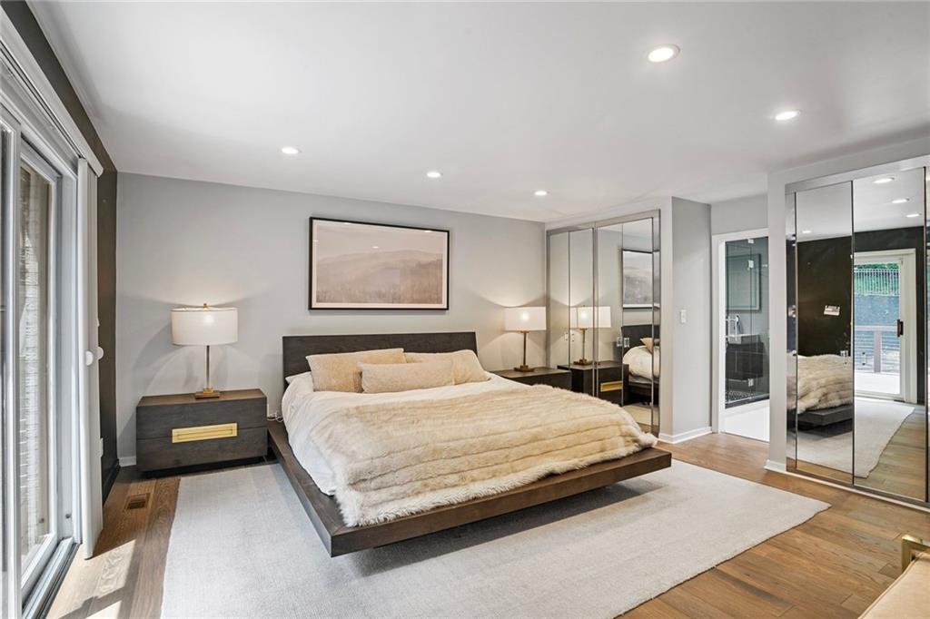 989 Braddock Road Pittsburgh, PA 15221 - Photo 21 of 50 a bedroom with a large bed and a large mirror