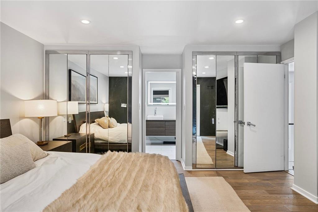 989 Braddock Road Pittsburgh, PA 15221 - Photo 22 of 50 a bedroom with a bed and a large mirror