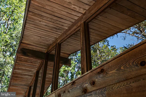 a view of balcony with wooden floor and fence