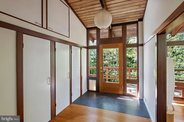 a view of an empty room with a window and balcony