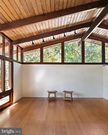 a view of a room with wooden floor