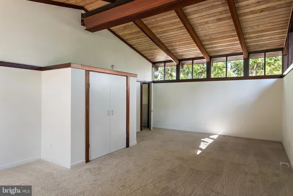 an empty room with large windows