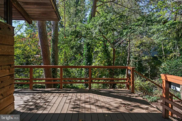 a view of balcony with wooden floor and fence