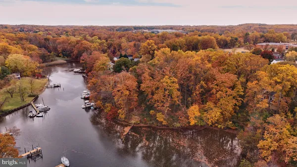 an aerial view of house with yard and mountain view in back