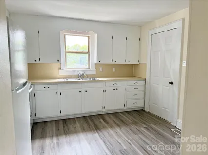 a view of cabinets and wooden floor