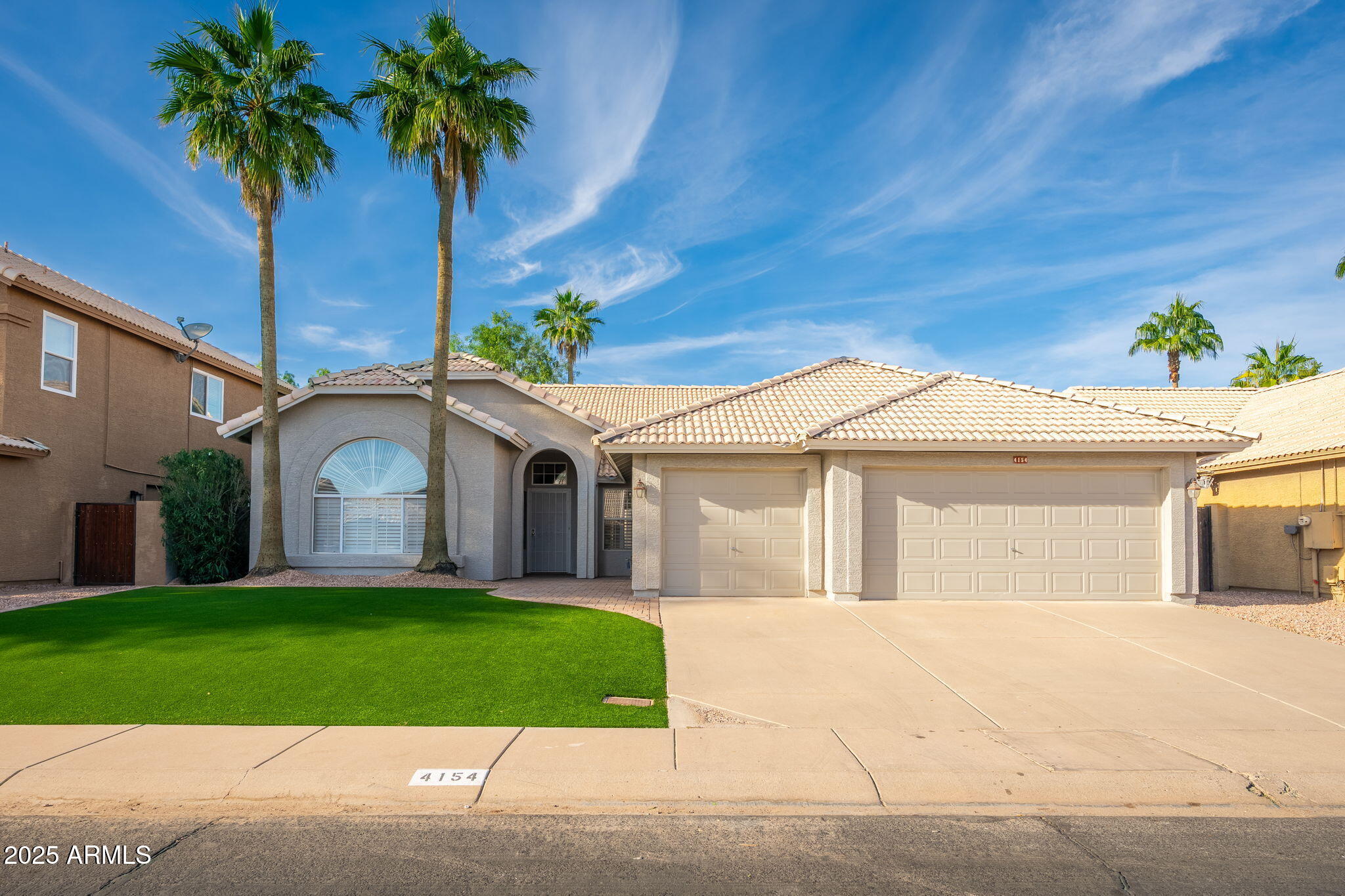 4154 East Rockledge Road Phoenix, AZ 85044 - Photo 1 of 41 a front view of a house with a garden and trees