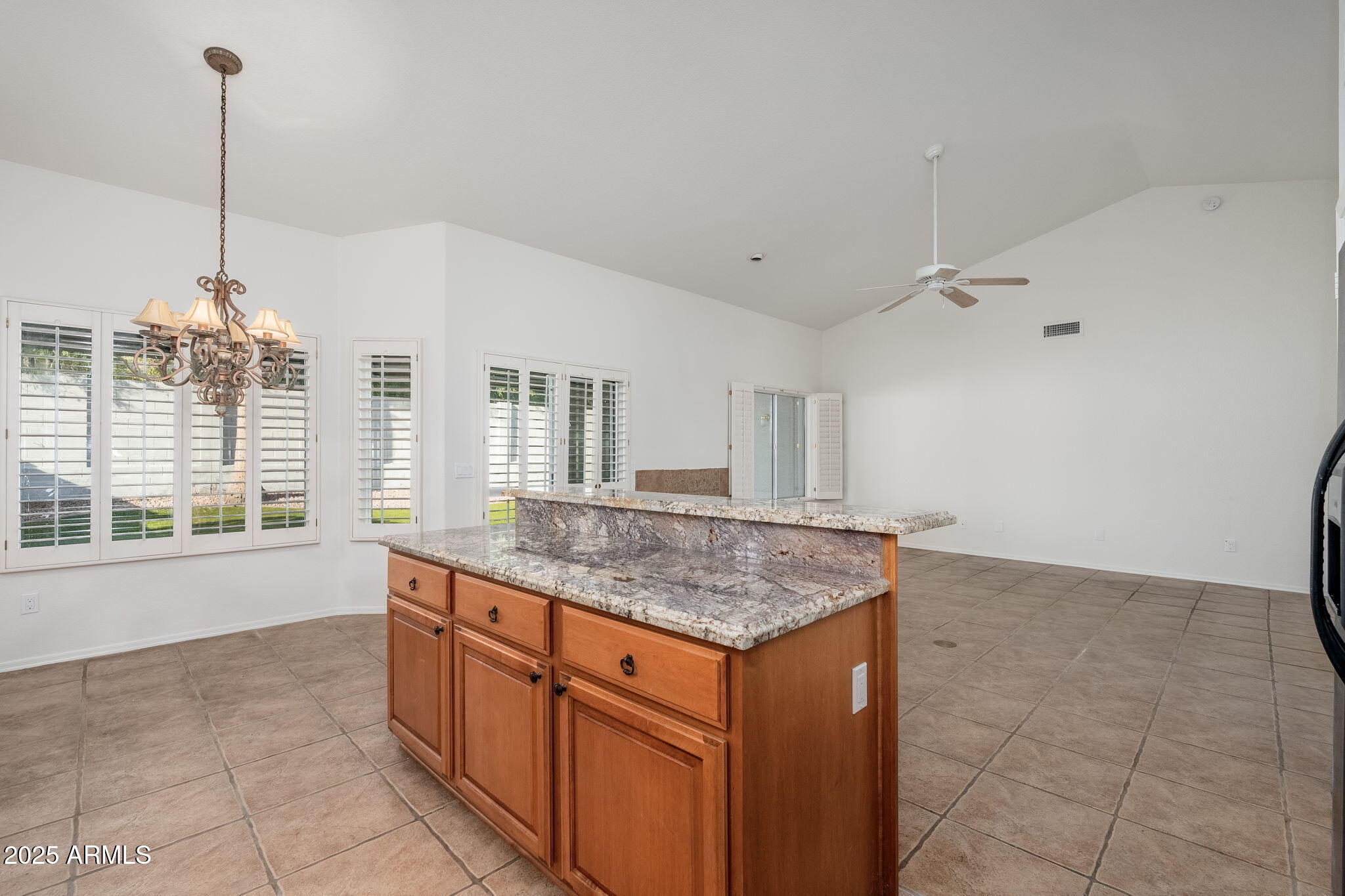 4154 East Rockledge Road Phoenix, AZ 85044 - Photo 9 of 41 a kitchen with stainless steel appliances granite countertop a stove a sink and a refrigerator