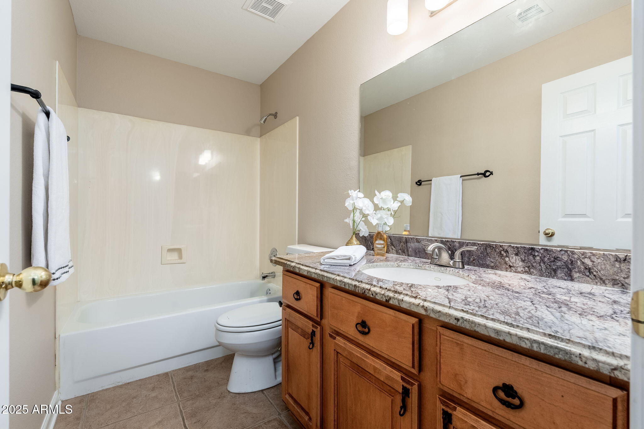 4154 East Rockledge Road Phoenix, AZ 85044 - Photo 11 of 41 a bathroom with a granite countertop sink a toilet and a large mirror