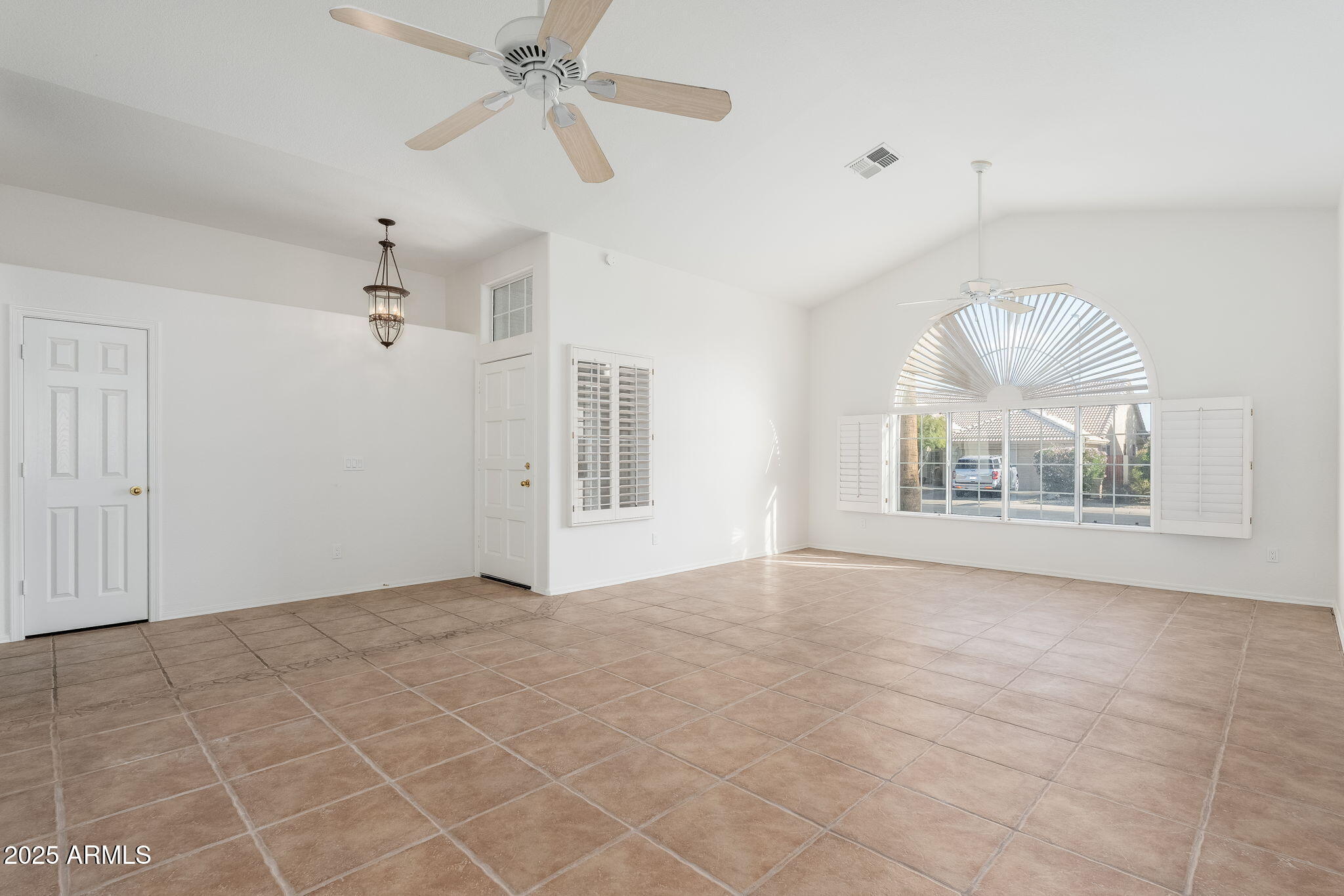 4154 East Rockledge Road Phoenix, AZ 85044 - Photo 23 of 41 an empty room with windows and fan