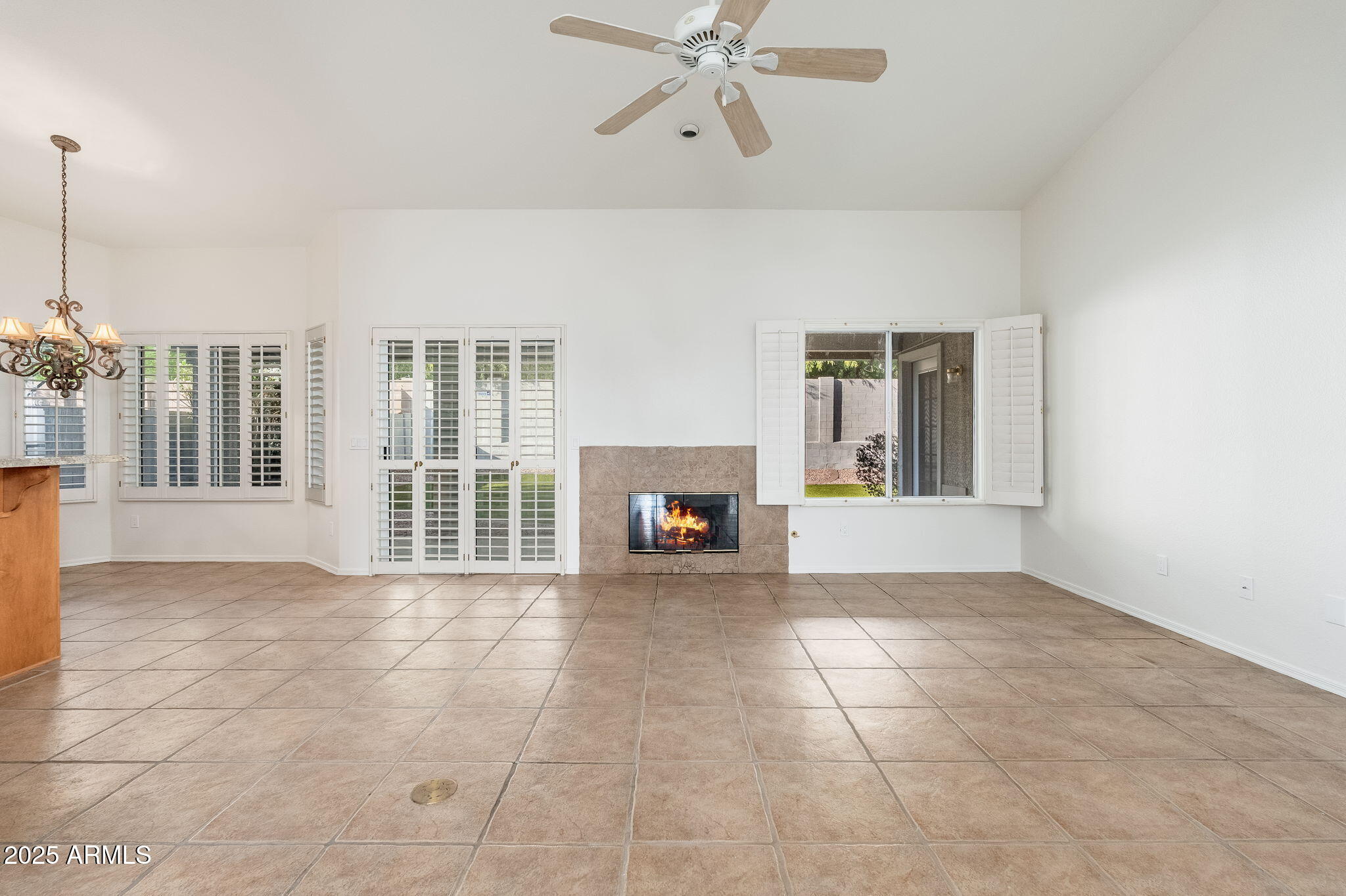 4154 East Rockledge Road Phoenix, AZ 85044 - Photo 27 of 41 a view of an empty room with a fireplace and a window