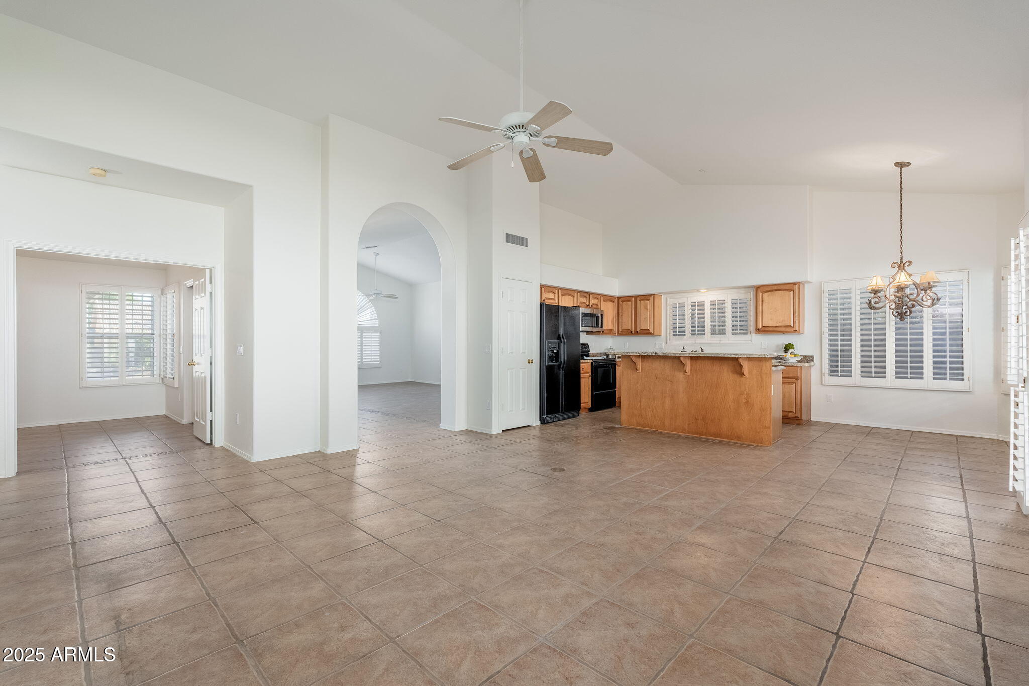 4154 East Rockledge Road Phoenix, AZ 85044 - Photo 29 of 41 a view of a kitchen with furniture and an empty room