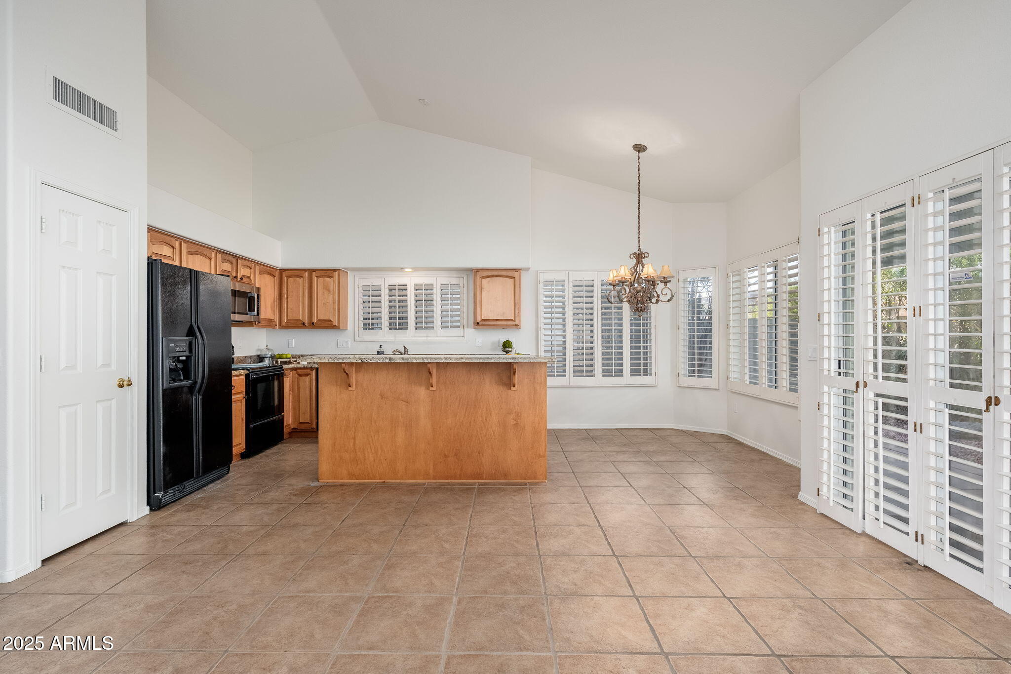 4154 East Rockledge Road Phoenix, AZ 85044 - Photo 30 of 41 a kitchen with stainless steel appliances granite countertop a refrigerator and a stove