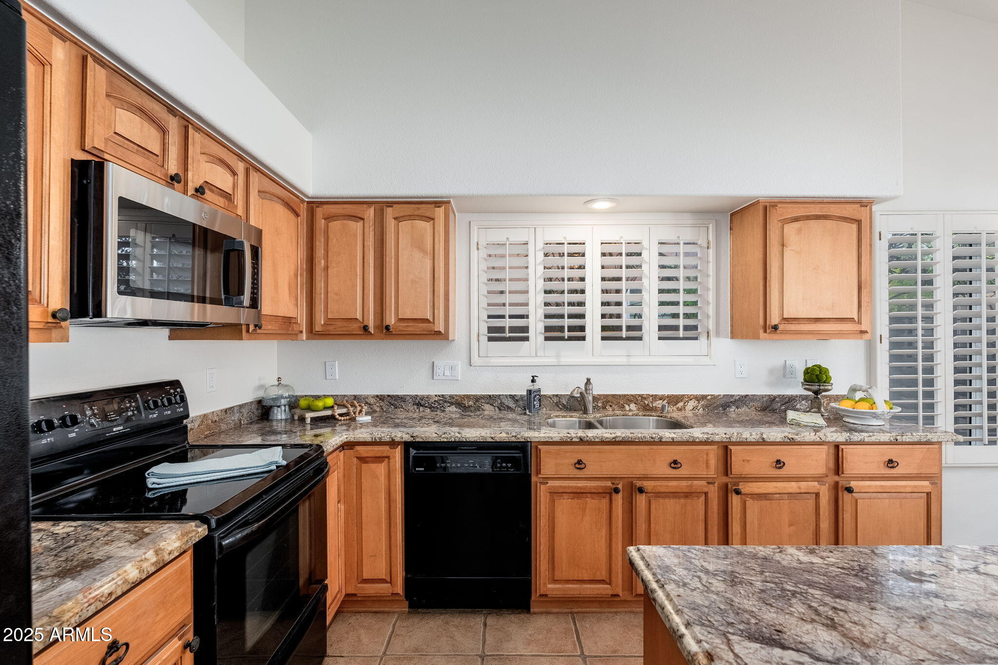 4154 East Rockledge Road Phoenix, AZ 85044 - Photo 6 of 41 a kitchen with stainless steel appliances granite countertop wooden cabinets stove top oven and granite counter top