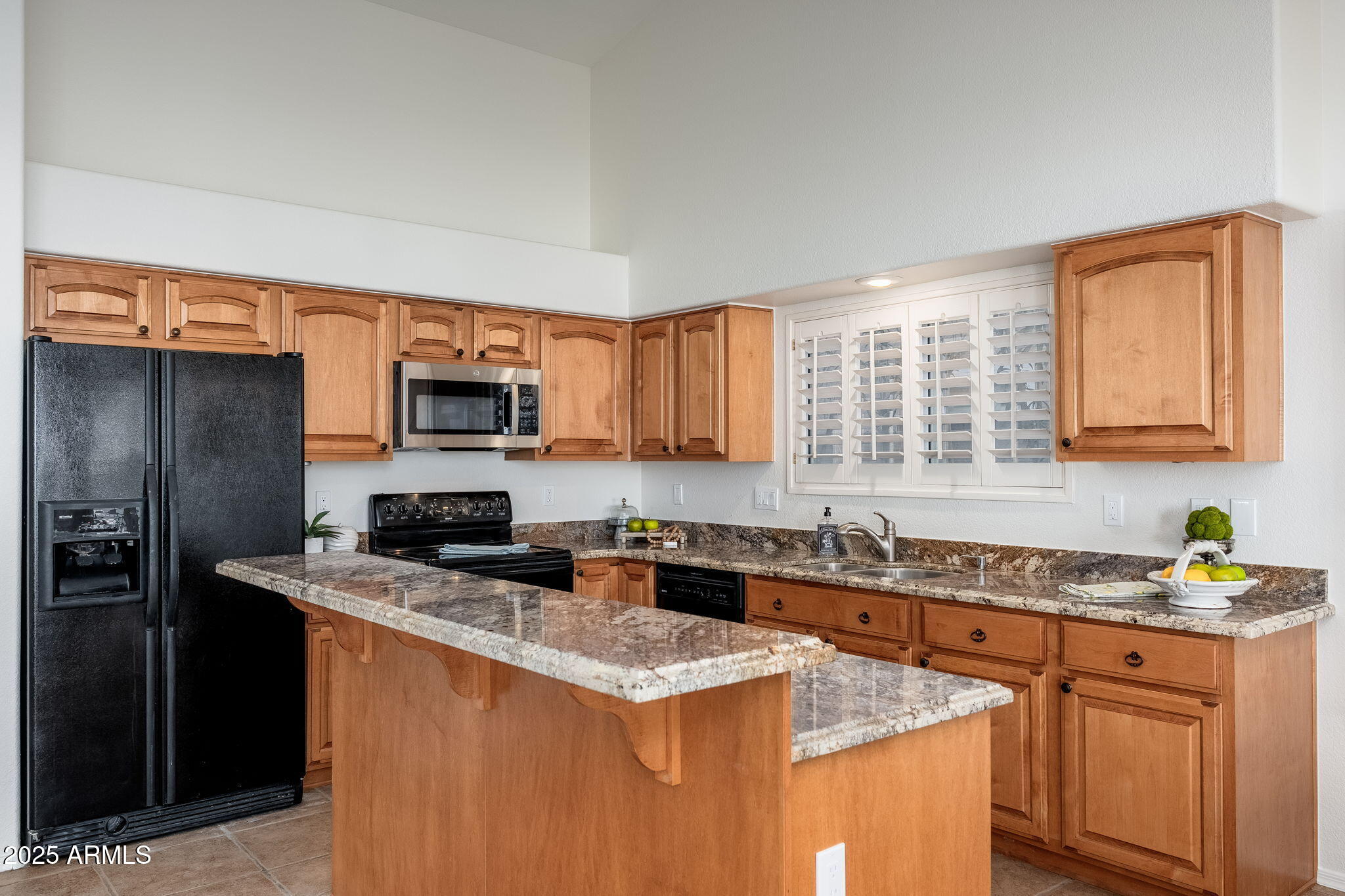 4154 East Rockledge Road Phoenix, AZ 85044 - Photo 8 of 41 a kitchen with stainless steel appliances granite countertop a sink stove microwave and refrigerator