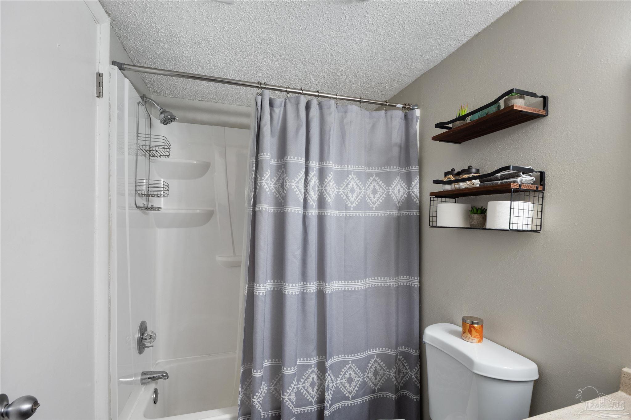 14100 River Road, Unit 122B Perdido Key, FL 32507 - Photo 28 of 46 a bathroom with a shower and a toilet