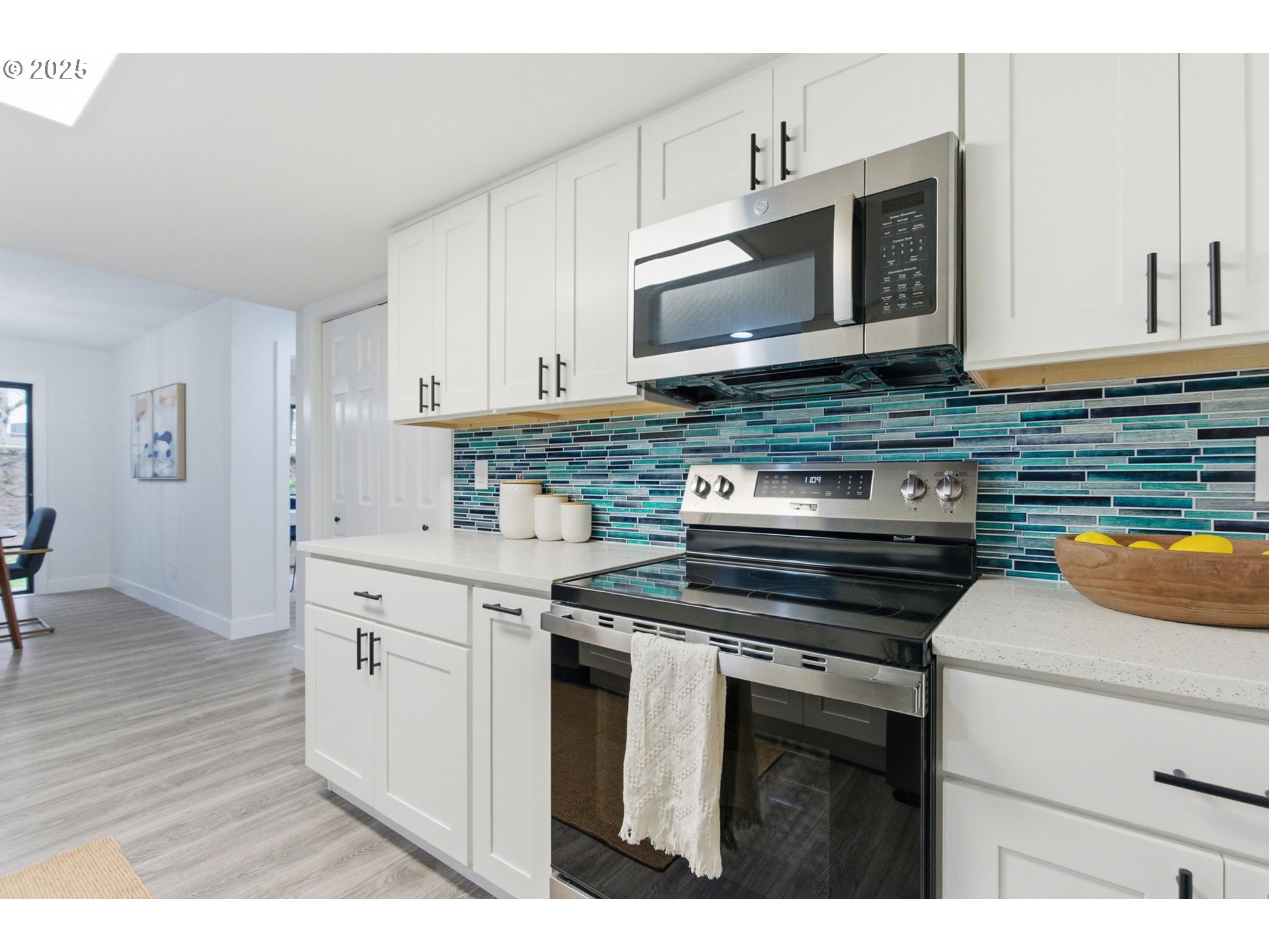 512 Southwest Eastman Parkway Gresham, OR 97080 - Photo 14 of 39 a kitchen with stainless steel appliances granite countertop a stove a microwave and a sink