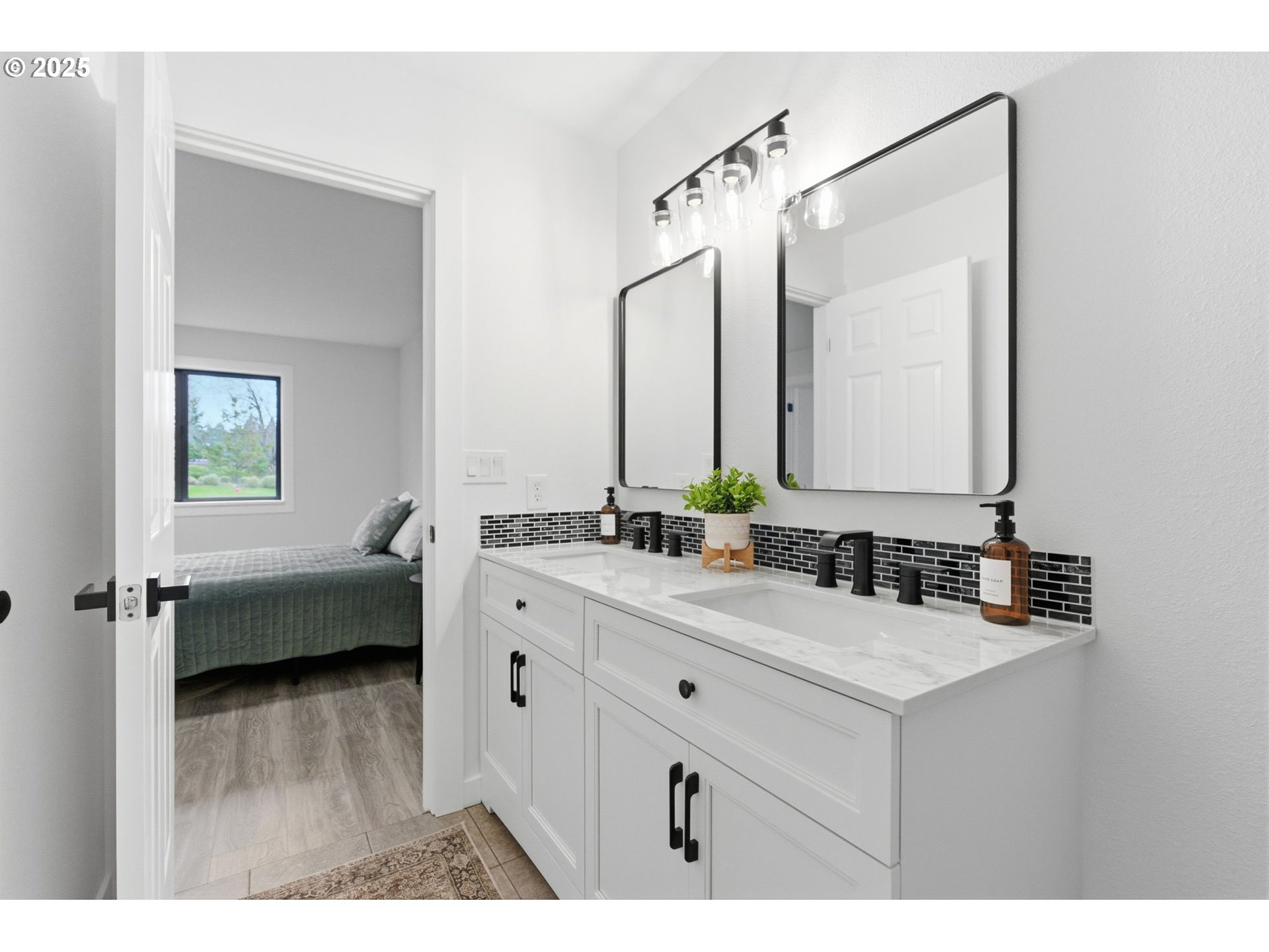 512 Southwest Eastman Parkway Gresham, OR 97080 - Photo 23 of 39 a en suite bathroom with a double vanity sink a mirror and a bathtub