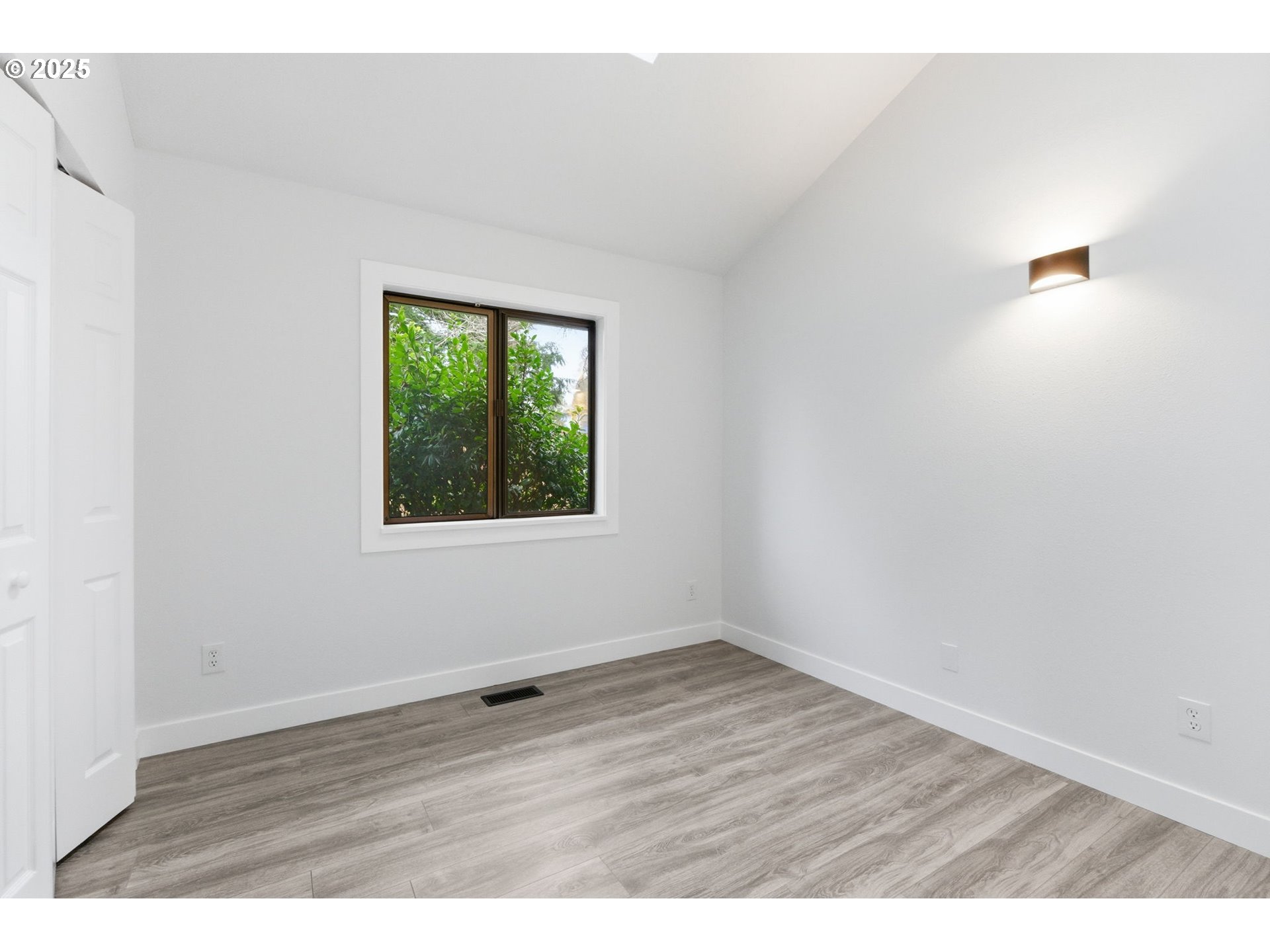 512 Southwest Eastman Parkway Gresham, OR 97080 - Photo 28 of 39 a view of an empty room with wooden floor and a window