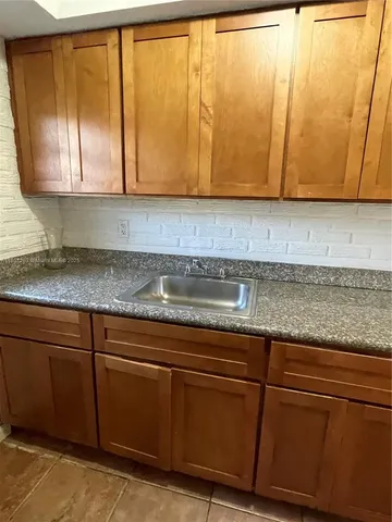 a kitchen with granite countertop cabinets and sink
