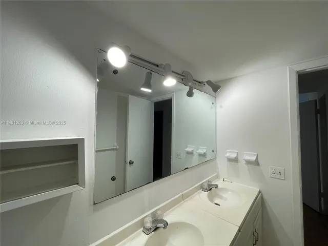 a bathroom with a sink double vanity and a mirror