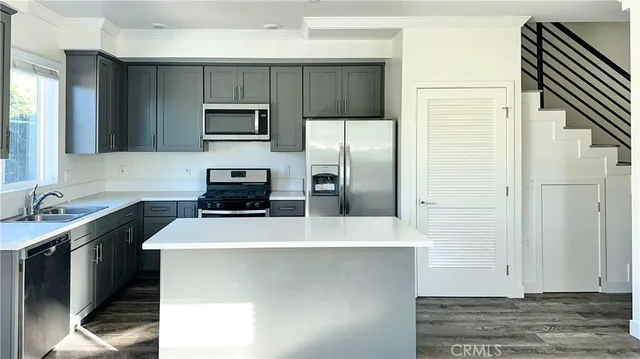 a kitchen with a sink and a refrigerator