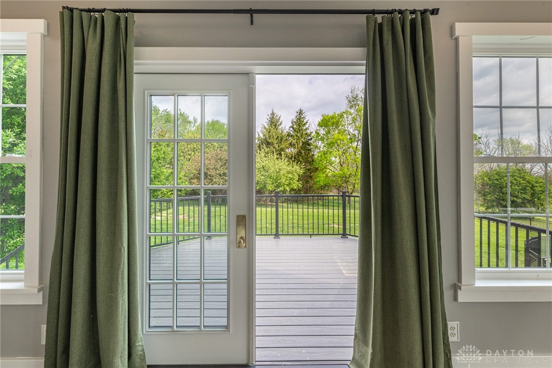 9586 Ferry Road Waynesville, OH 45068 - Photo 9 of 40 This inviting home offers seamless indoor-outdoor living with a spacious deck overlooking lush greenery.