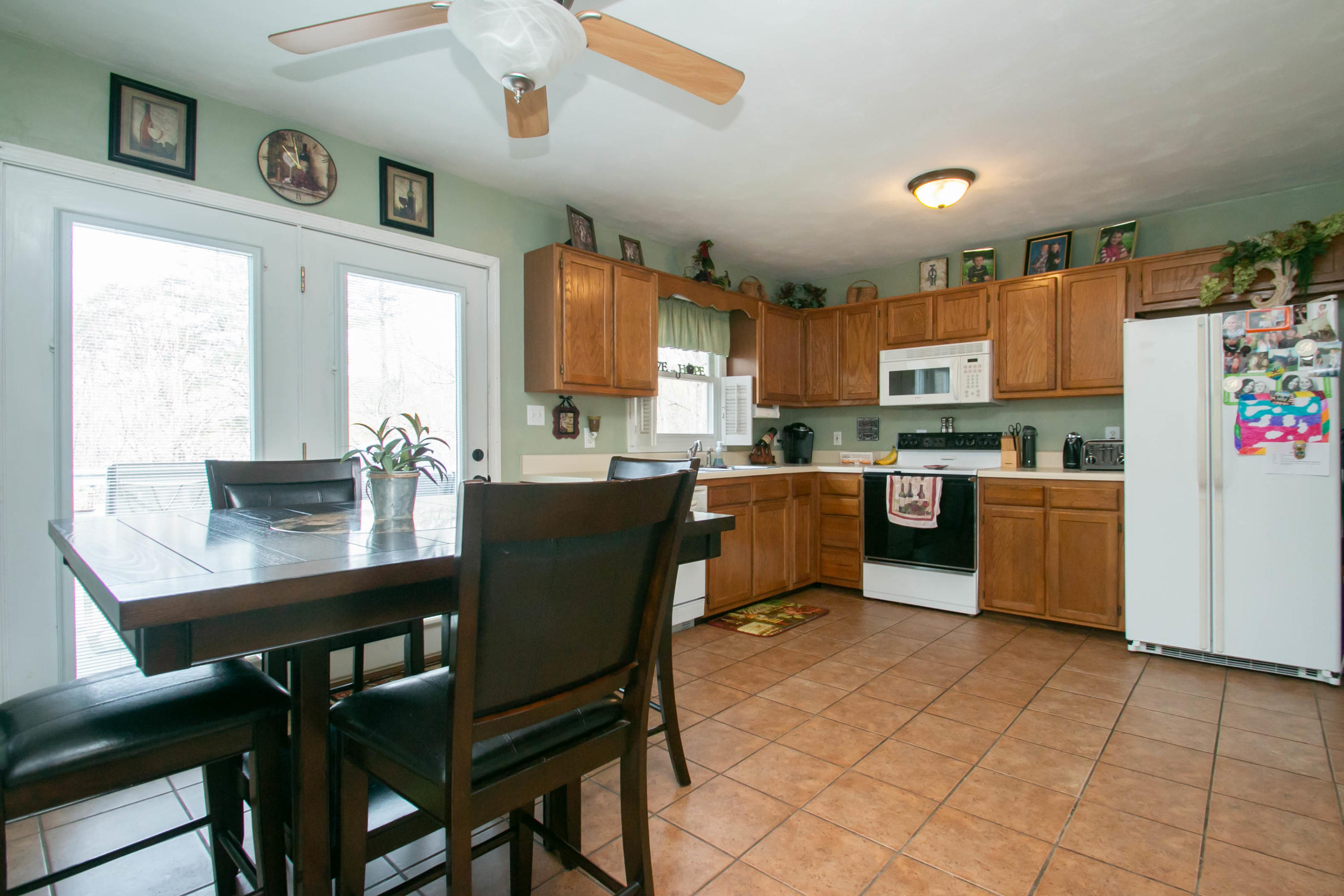 1037 Chandler Road Goodview, VA 24095 - Photo 5 of 21 a kitchen with a table chairs microwave and cabinets