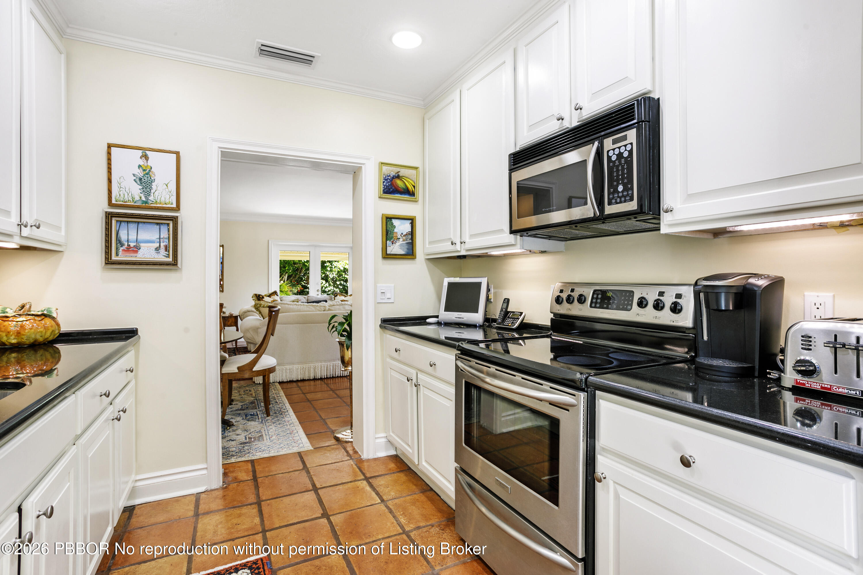 380 Cocoanut Row, Unit 1 Palm Beach, FL 33480 - Photo 13 of 32 a kitchen with stainless steel appliances a stove a microwave and cabinets