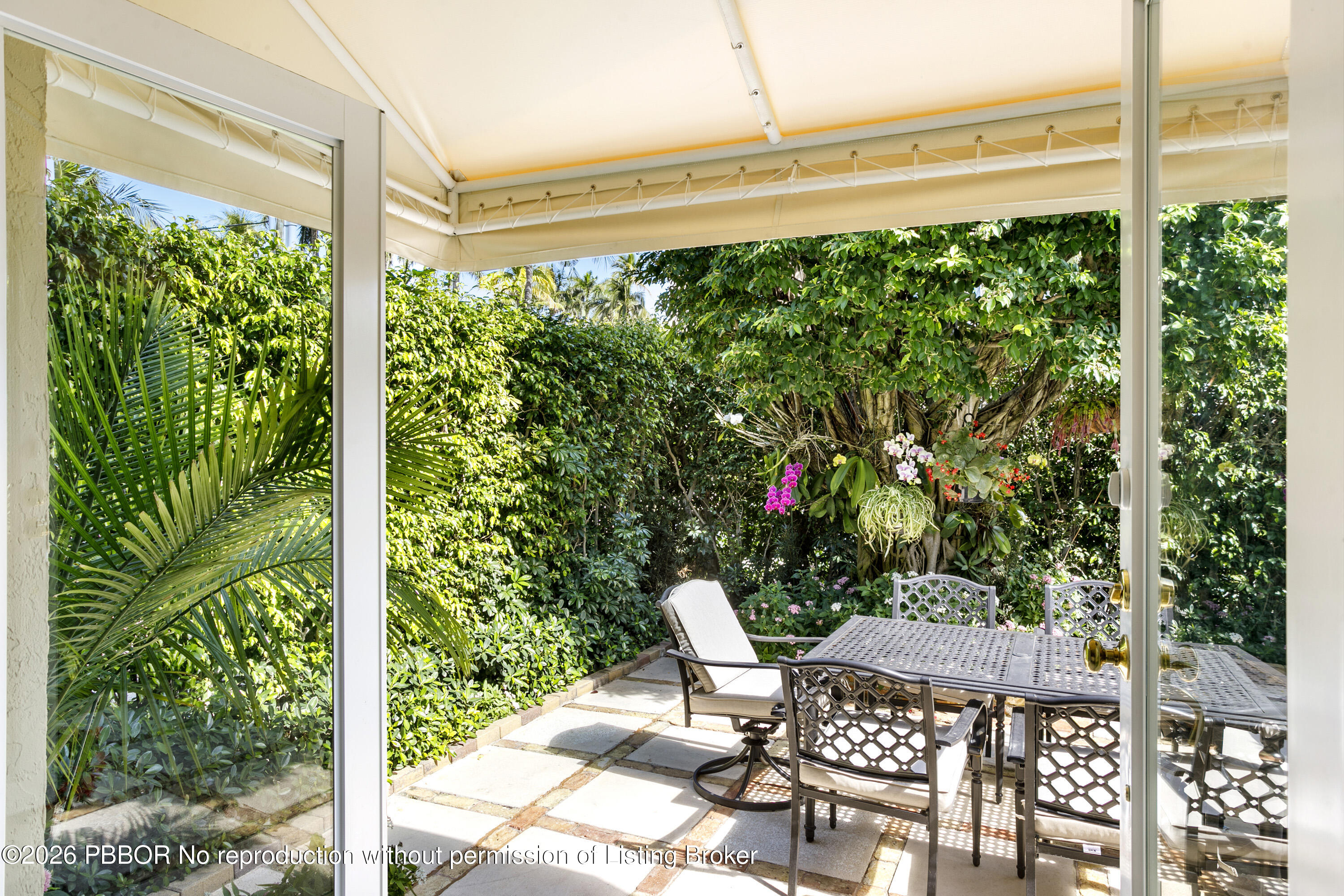 380 Cocoanut Row, Unit 1 Palm Beach, FL 33480 - Photo 7 of 32 a patio with table and chairs and potted plants