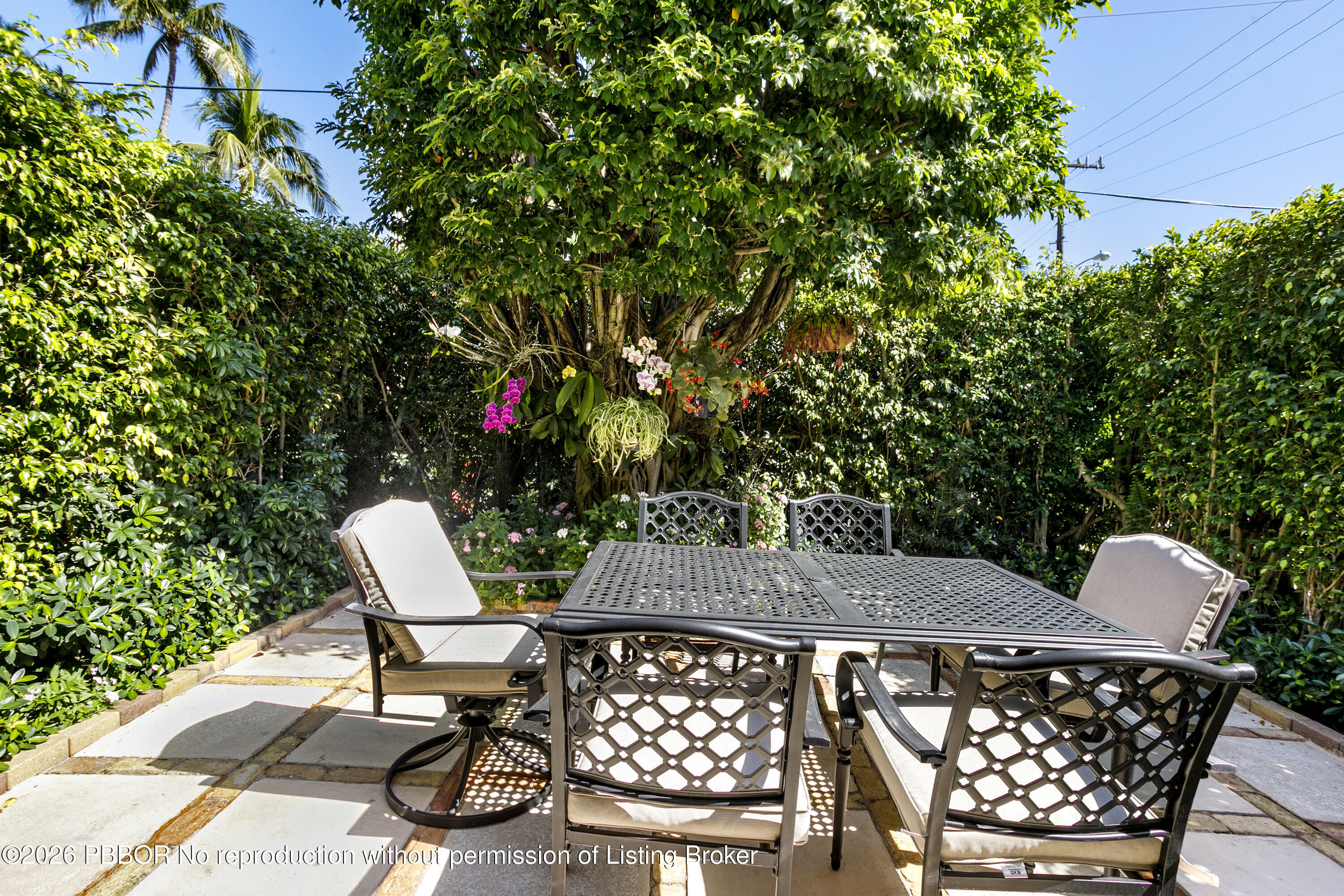 380 Cocoanut Row, Unit 1 Palm Beach, FL 33480 - Photo 10 of 32 a patio with table and chairs and potted plants