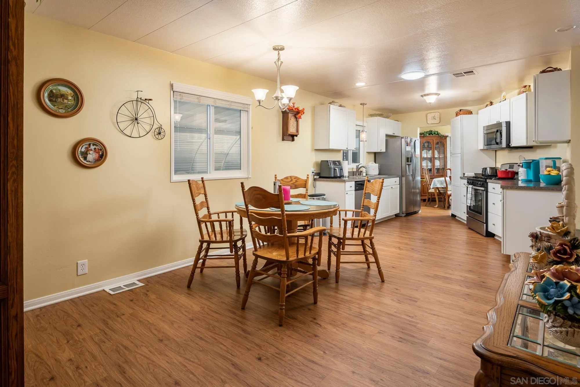 262 Brookside Lane Oceanside, CA 92056 - Photo 11 of 43 a dining room with furniture and wooden floor
