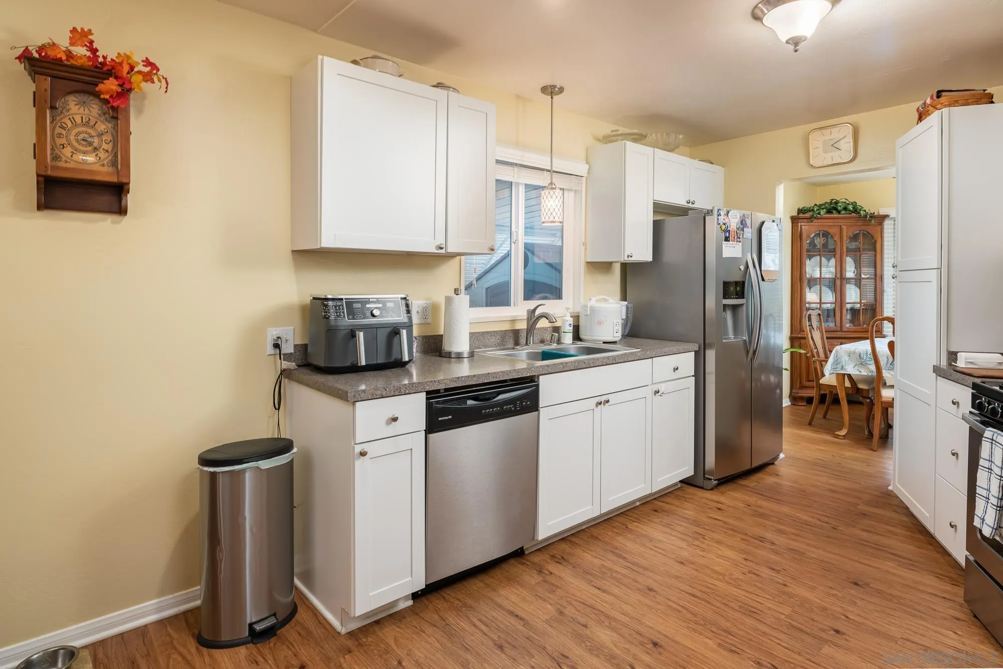 262 Brookside Lane Oceanside, CA 92056 - Photo 12 of 43 a kitchen with stainless steel appliances a sink cabinets and wooden floor