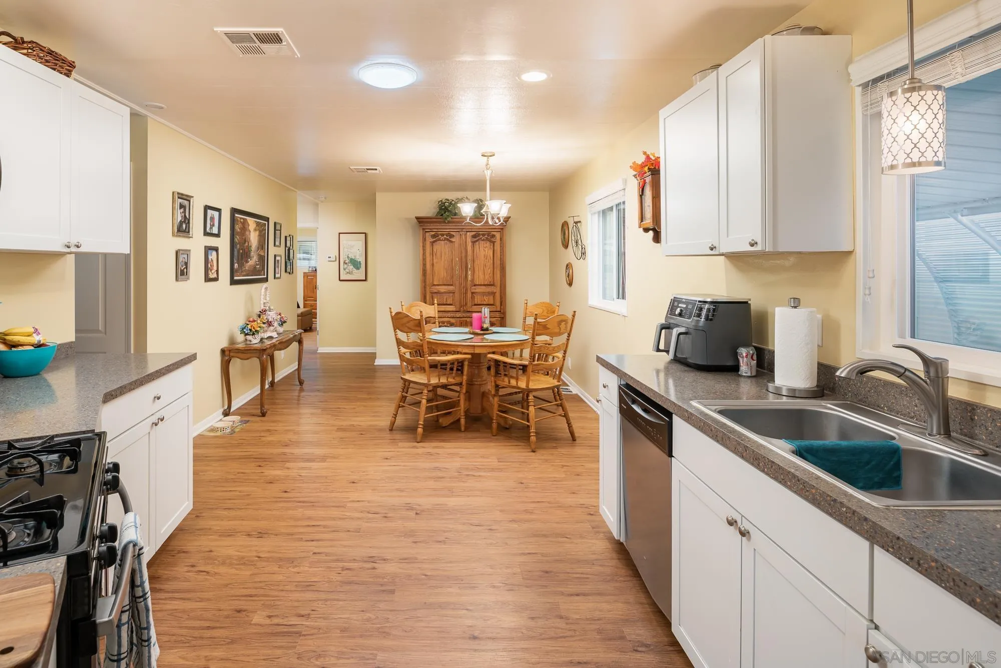 262 Brookside Lane Oceanside, CA 92056 - Photo 13 of 43 a kitchen with stainless steel appliances sink stove top oven and cabinets