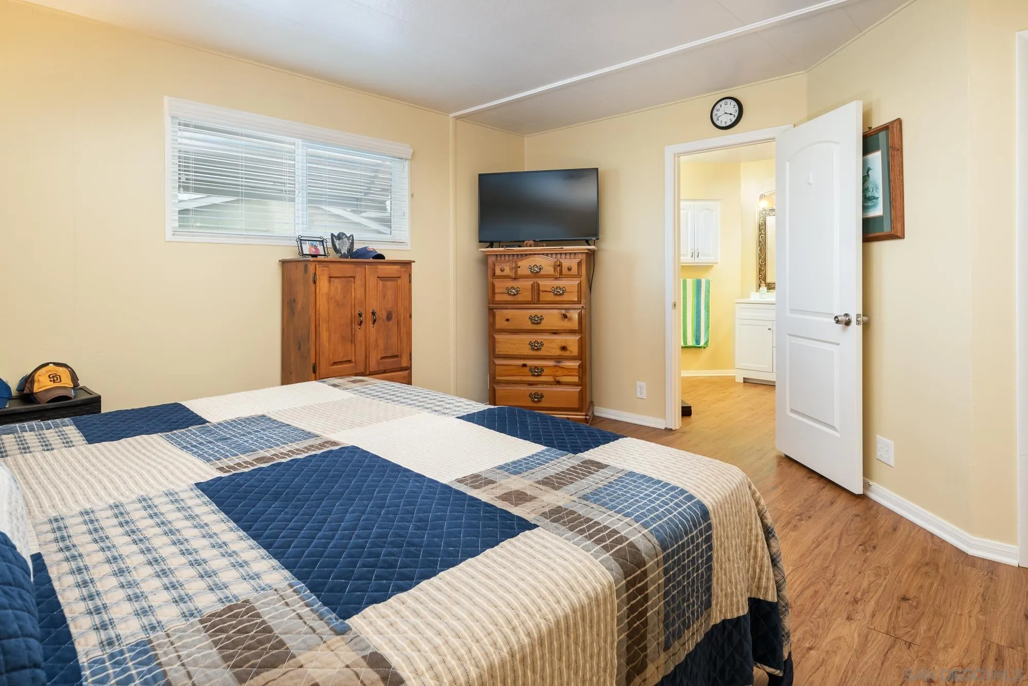 262 Brookside Lane Oceanside, CA 92056 - Photo 15 of 43 a bedroom with a bed and wooden floor