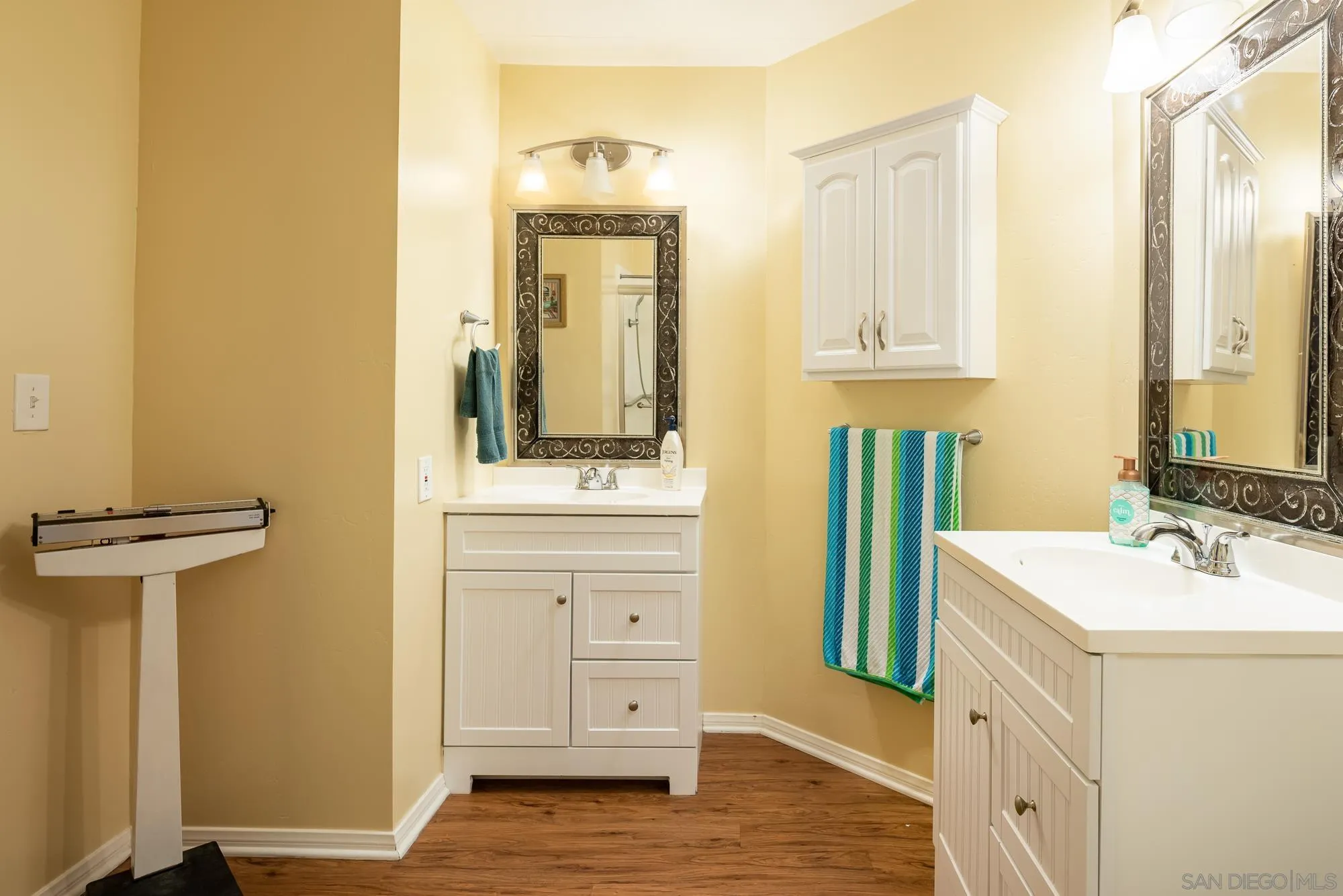 262 Brookside Lane Oceanside, CA 92056 - Photo 16 of 43 a bathroom with a sink a mirror and a shower