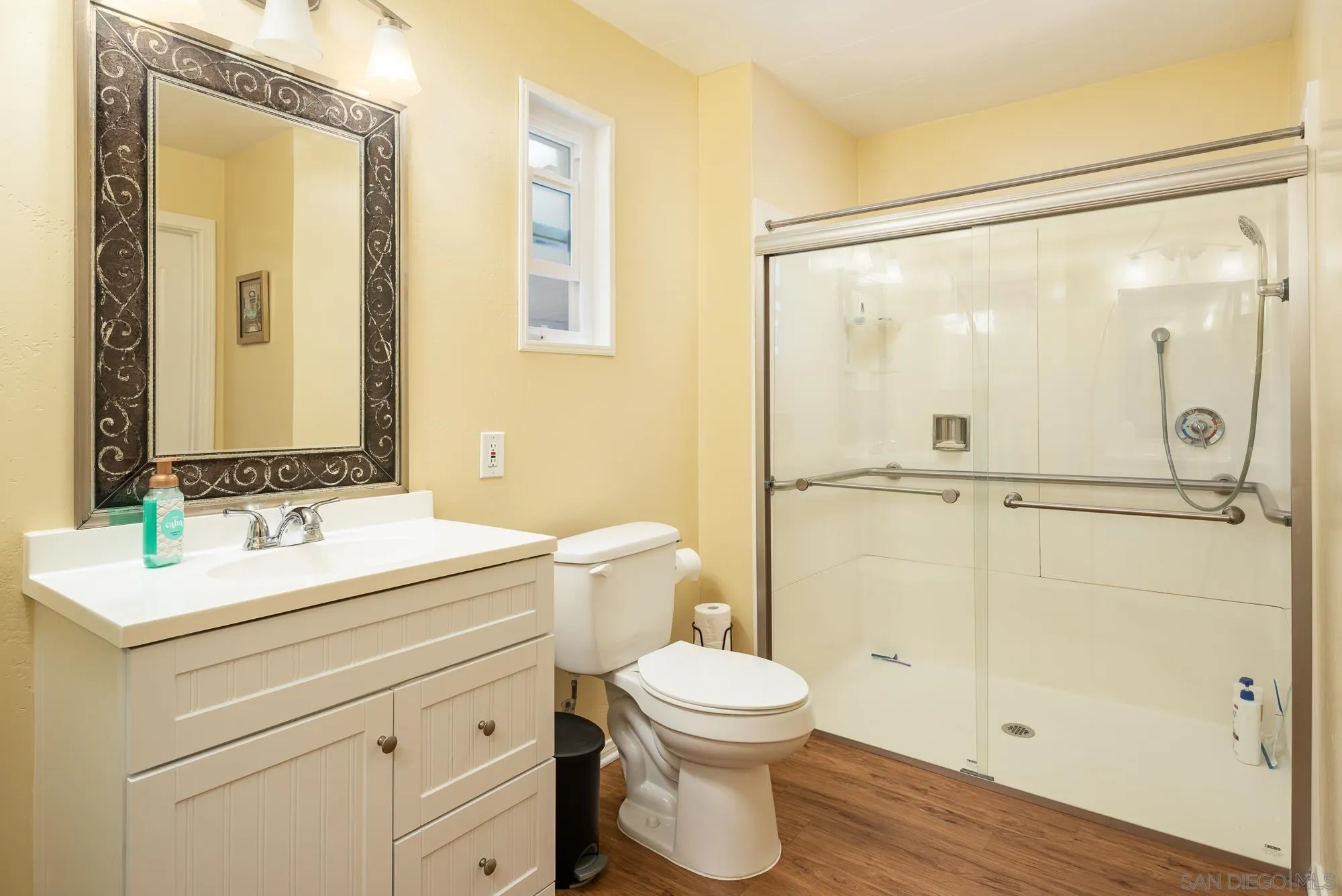 262 Brookside Lane Oceanside, CA 92056 - Photo 17 of 43 a bathroom with a sink a mirror a toilet and shower